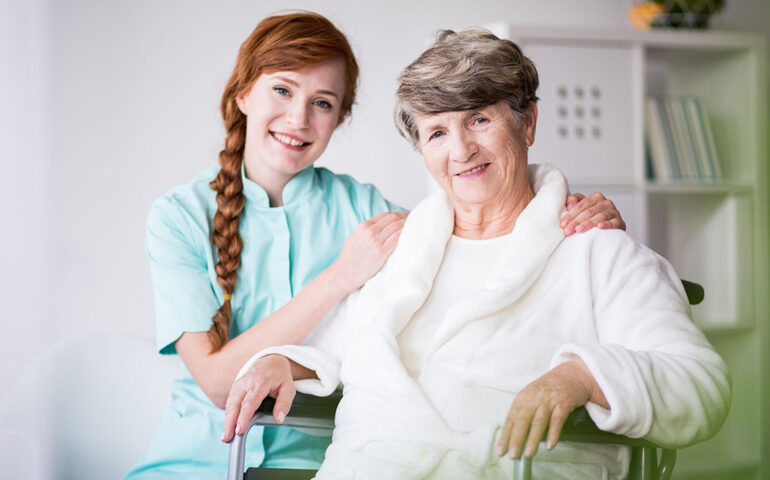 Nurse with woman with hands on shoulders